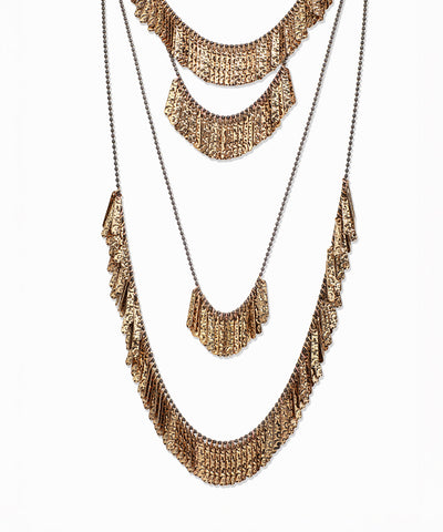 Gold-tone layered necklace with textured fringe and gunmetal-tone chains
