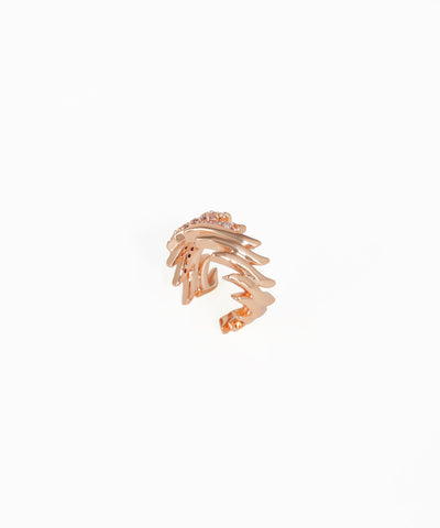Rose gold ring with a unique design on a white background