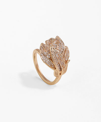 Rose gold ring with leaf design and clear stones on a white background
