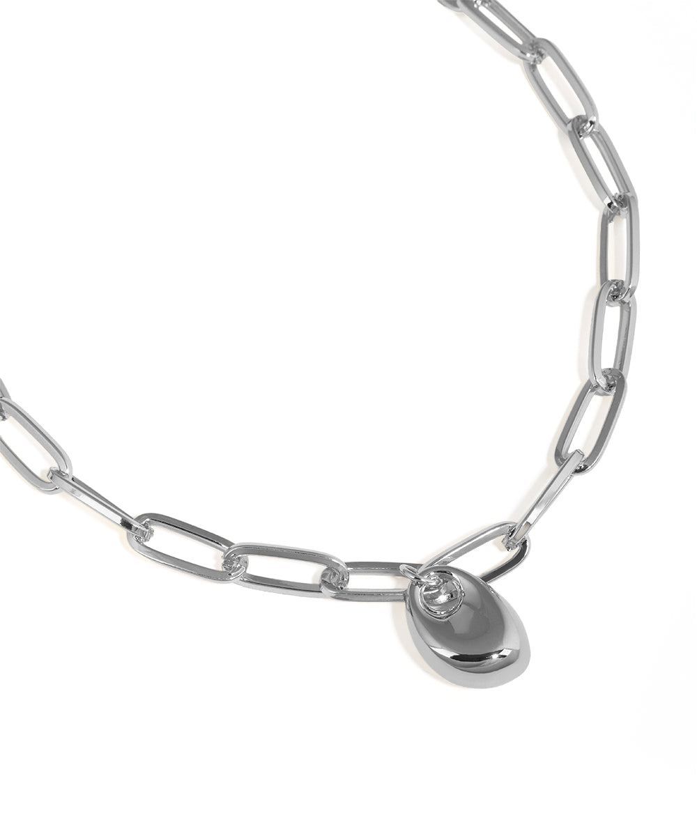 Silver chain necklace with a heart-shaped pendant on a white background