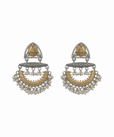 Pair of ornate earrings with gold and silver design on a white background