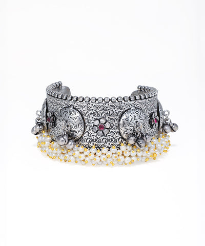 Silver elephant bracelet with beads on a white background