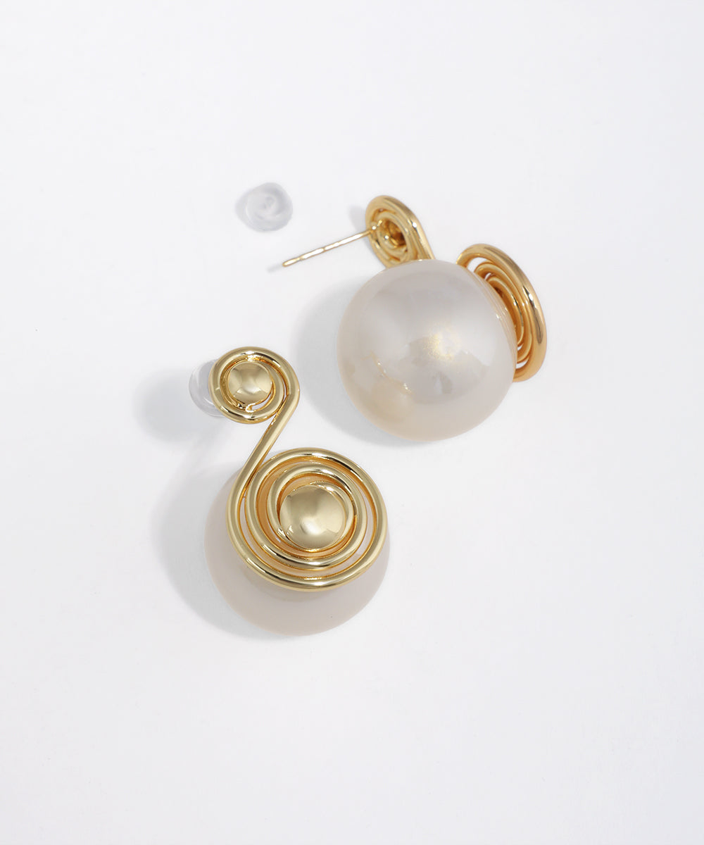 Gold-tone earrings with abstract wire swirl and large faux pearl orb