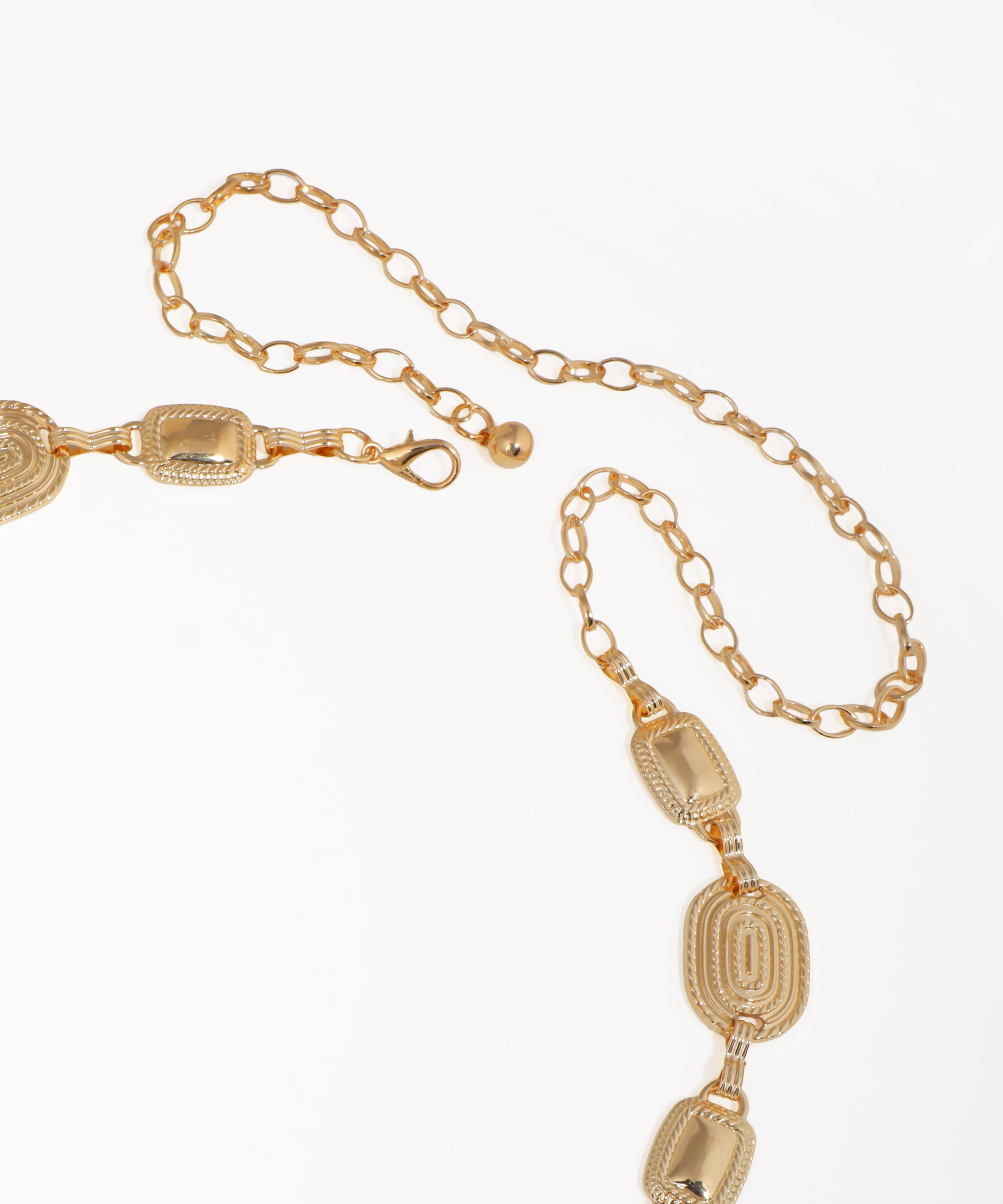 Gold chain necklace with decorative links on a white background
