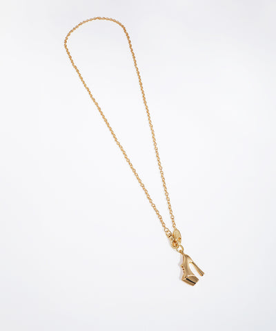 Gold-tone pendant necklace with a detailed stiletto heel charm on a delicate chain.