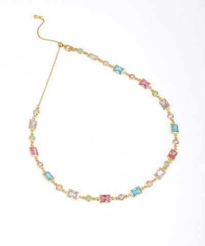 Gold-tone necklace with spaced rectangular and round pastel glass crystals and an adjustable slider