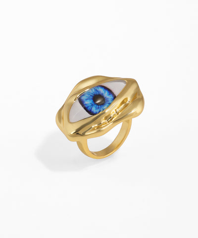 Gold ring with a blue eye design on a white background