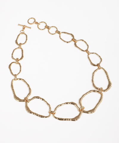 Gold-tone necklace with chunky abstract textured links and toggle clasp