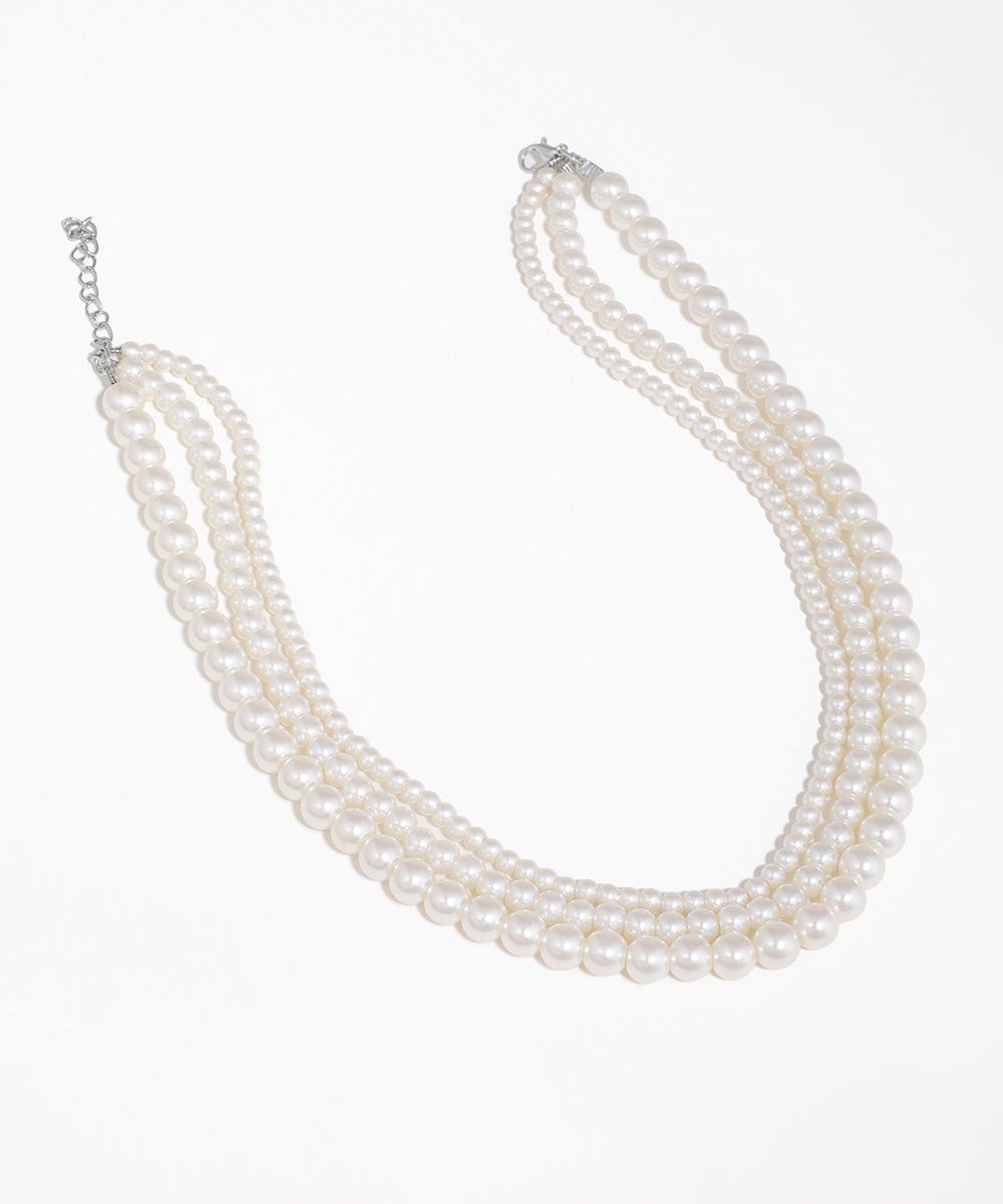 Silver-tone triple strand necklace with graduated faux pearls