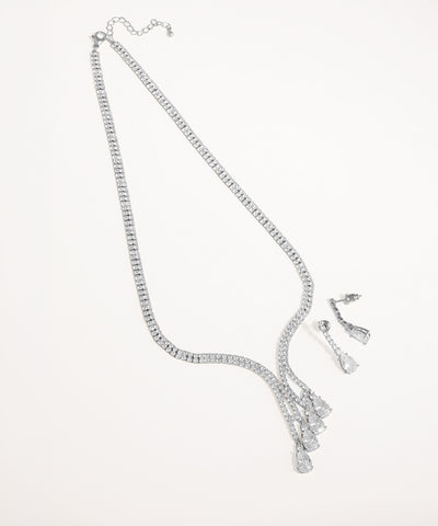 Silver necklace and earrings set on a white background