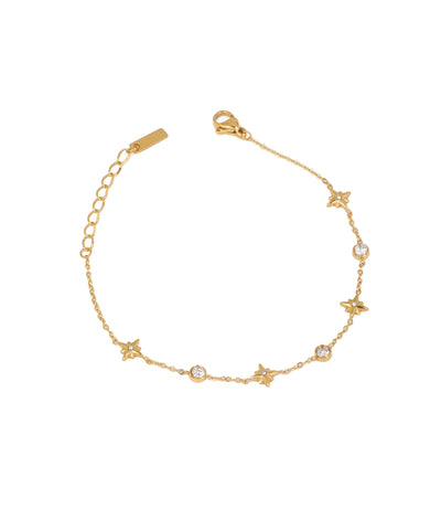 Gold-tone bracelet with alternating star charms and round bezel-set CZ stones on a delicate chain.