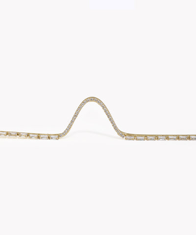 Gold bracelet with diamond accents on a white background