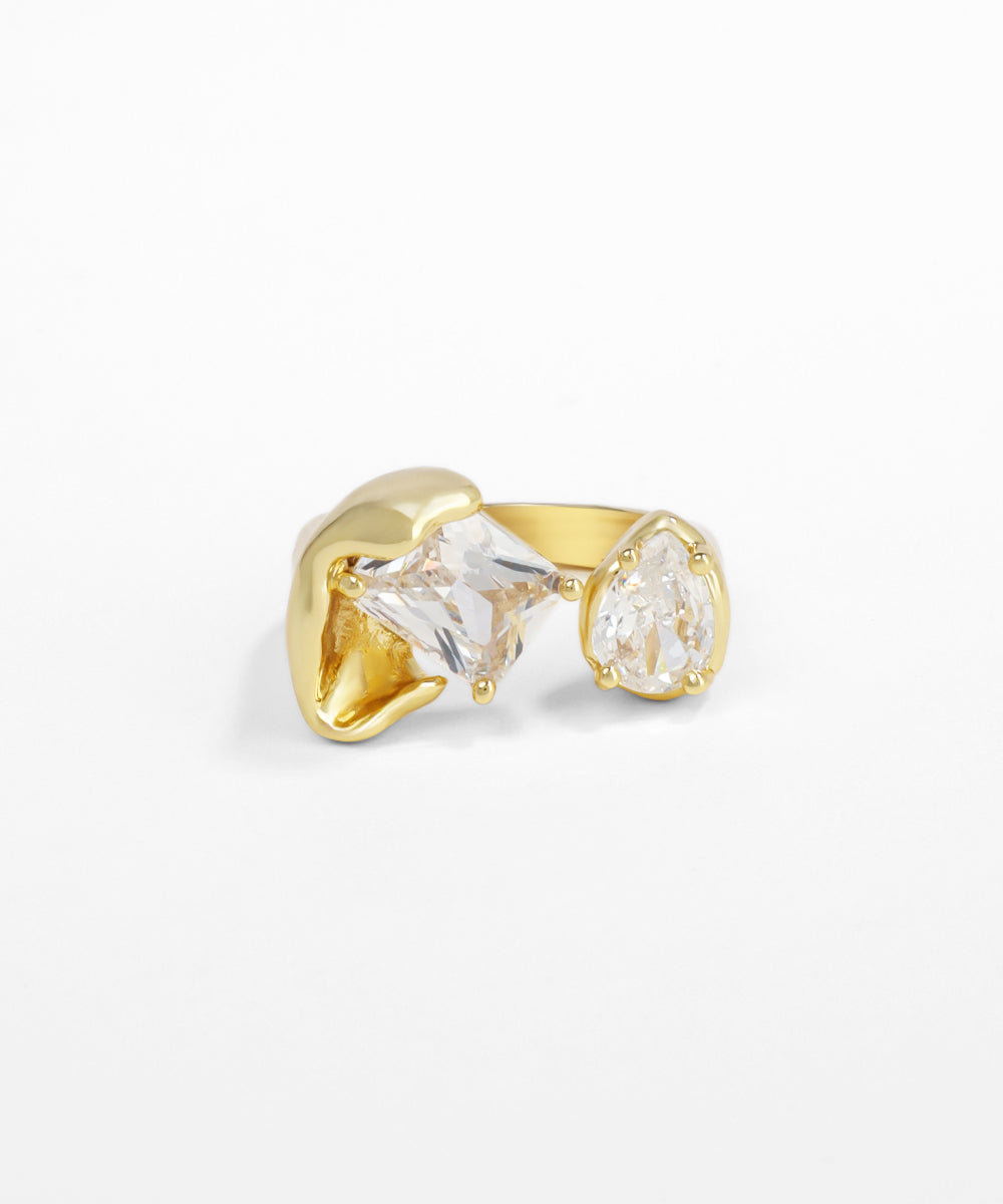 Gold earrings with clear gemstones on a white background