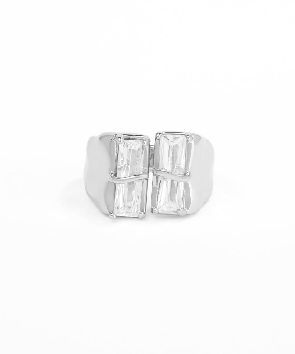 Silver ring with baguette-cut gemstones on a white background