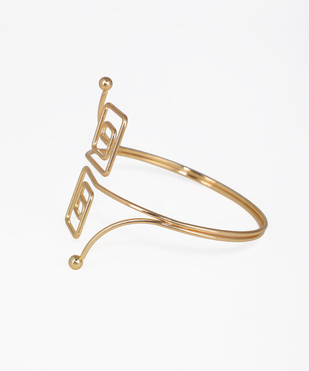 Gold bracelet on a light beige background