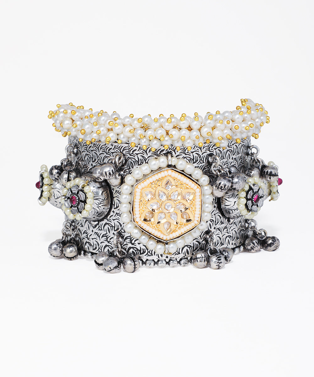 Decorative bracelet with intricate design on a white background