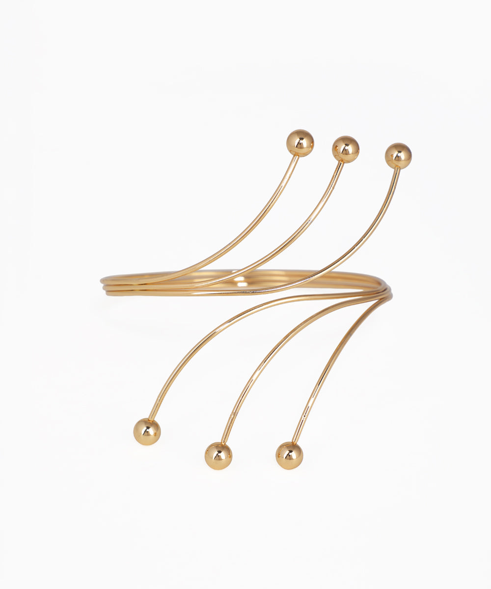 Gold bracelet with multiple curved arms and spherical ends on a white background