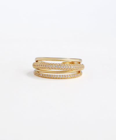 Set of gold rings with embedded diamonds on a white background