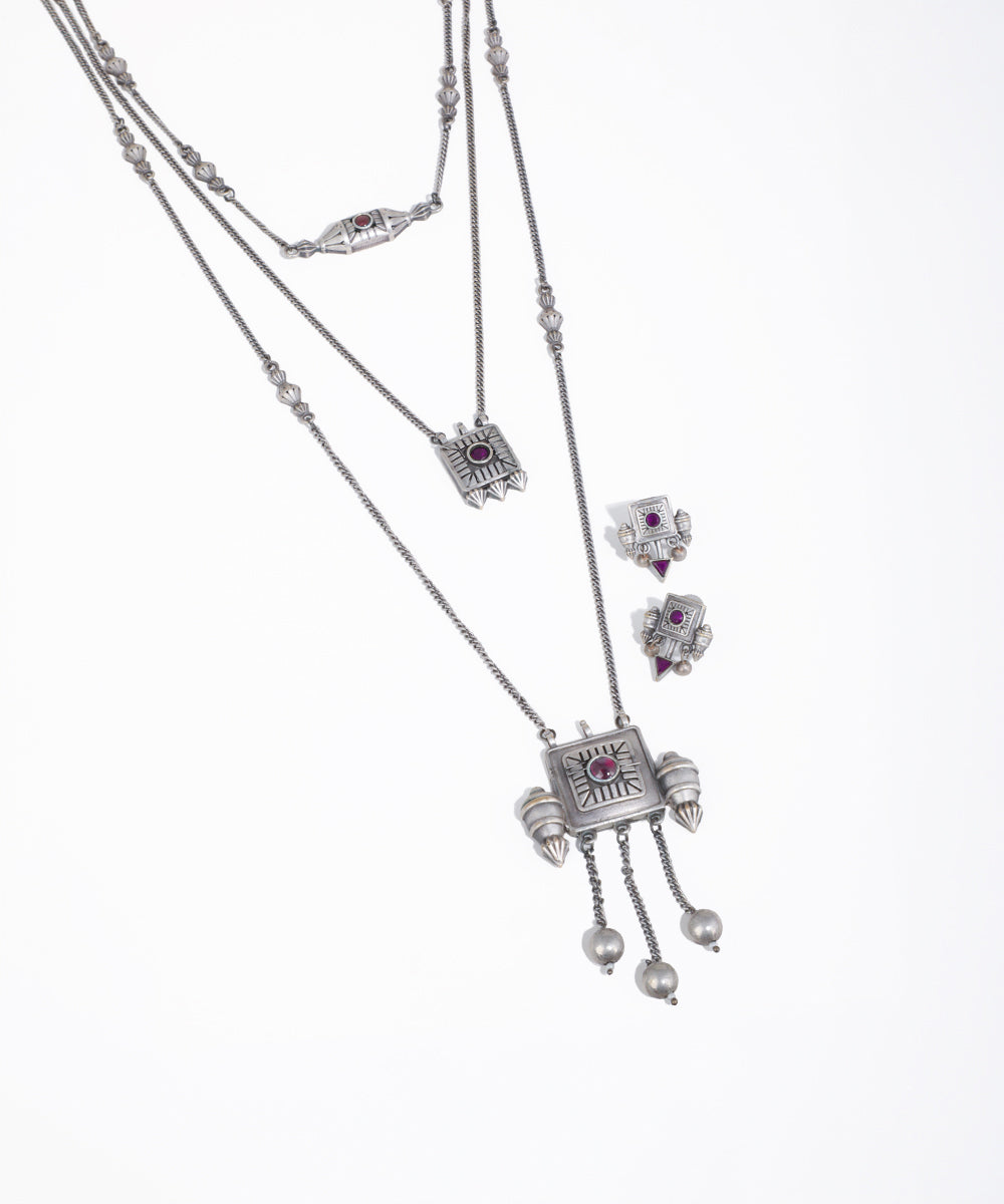 Silver necklace with gemstone pendants on a white background