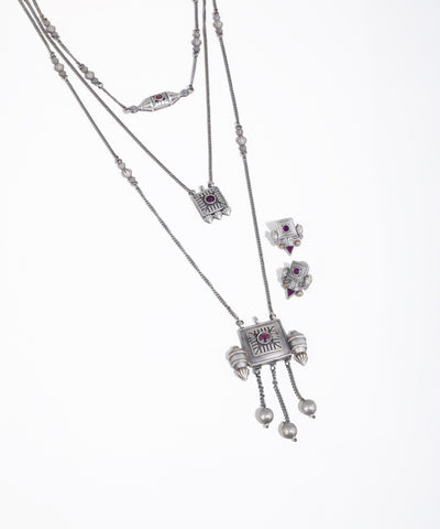 Silver necklace with gemstone pendants on a white background