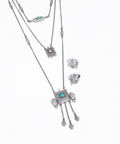 Silver necklace with turquoise stones on a white background