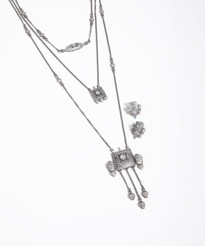 Silver necklace with pendant and matching earrings on a white background