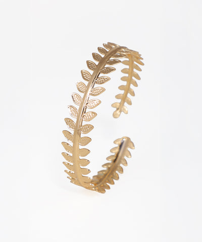 Gold leaf-shaped earring on a white background