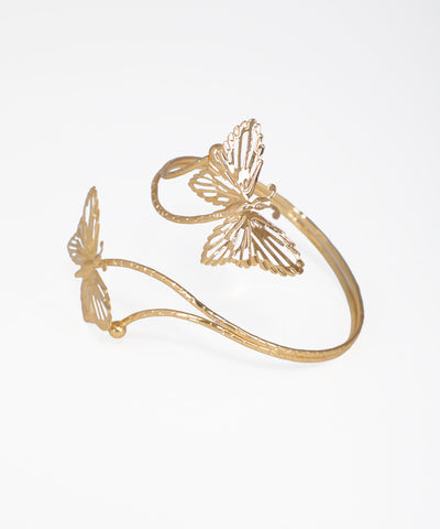 Gold butterfly-shaped bracelet on a white background