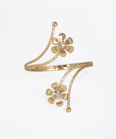 Gold bracelet with floral designs on a white background