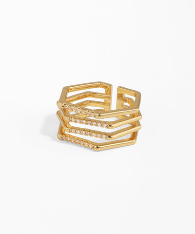 Gold ring with geometric design on a white background