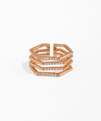 Rose gold ring with geometric design on a white background