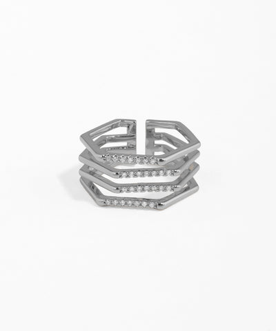 Stack of silver hexagonal rings with small stones on a white background