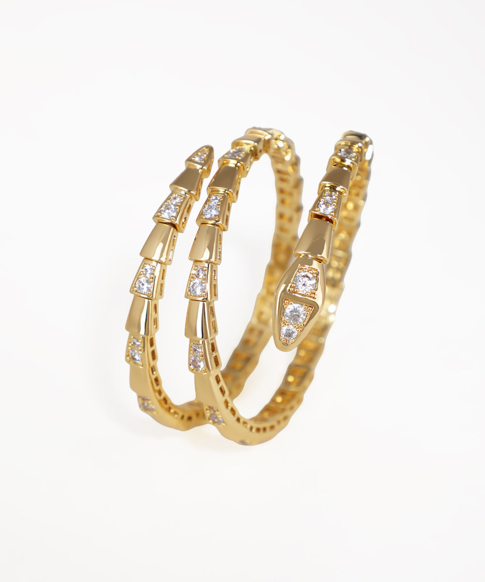 Gold hoop earrings with embedded diamonds on a white background