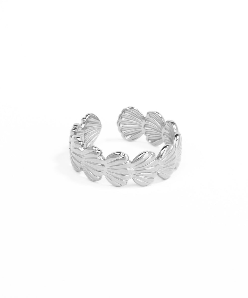 Silver shell-shaped bracelet on a white background