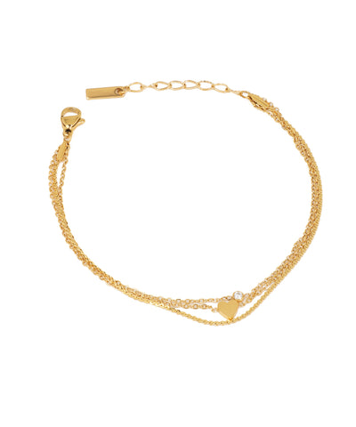 Gold-tone bracelet with delicate layered chains, a heart charm, and a single clear stone