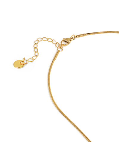 Gold bracelet with a heart charm on a white background