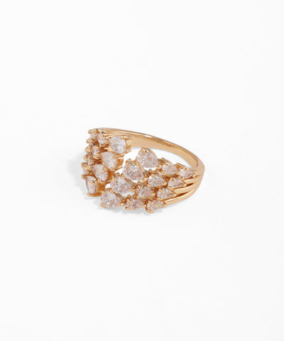 Gold ring with diamond-like stones on a white background