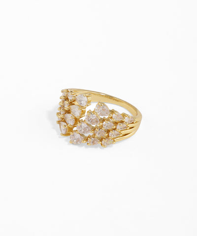 Gold ring with diamond-like stones on a white background