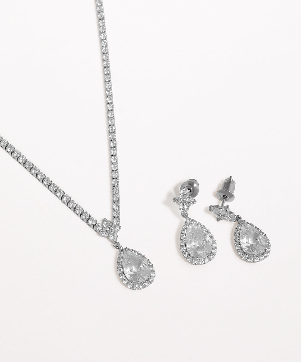 Silver teardrop necklace and earrings on a white background