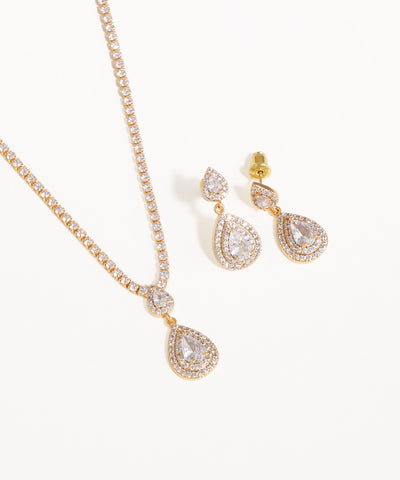 Gold necklace and earrings with teardrop designs on a white background