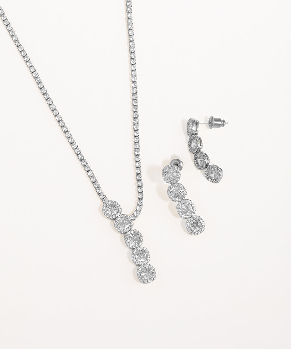 Silver necklace and earrings set on a white background