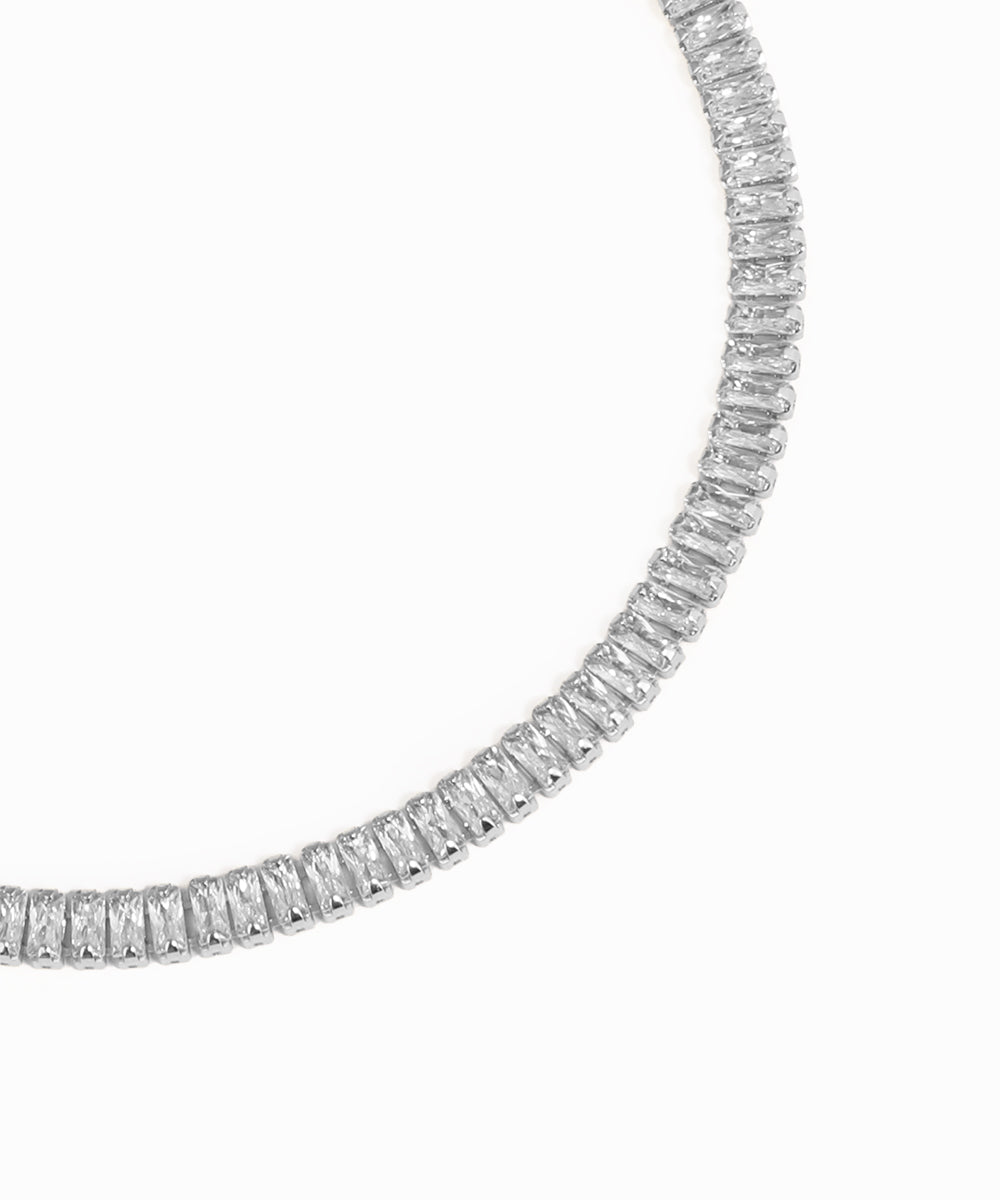 Rose gold necklace with clear gemstones on a white background