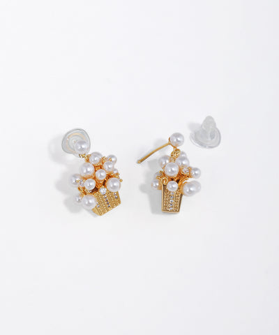 Gold-tone cluster earrings with faux pearls and CZ stones set in a textured basket design.