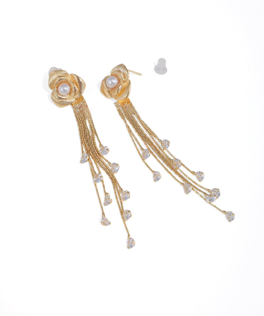 Gold-tone drop earring with textured floral top, faux pearl, and multiple dangling chains with CZ crystal drops