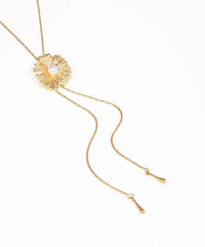 Gold necklace with a floral design on a white background