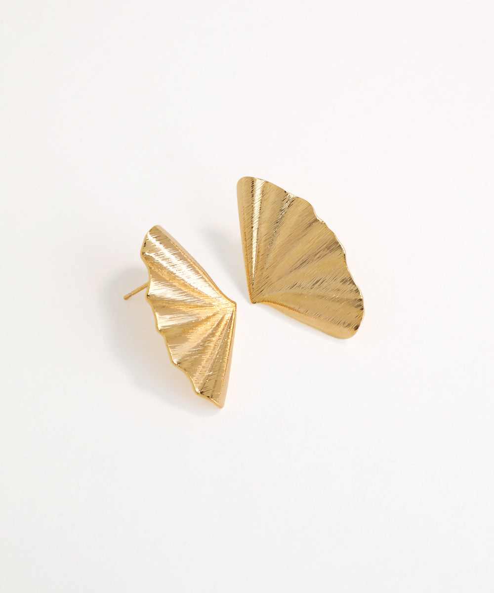 Gold fan-shaped earrings on a white background