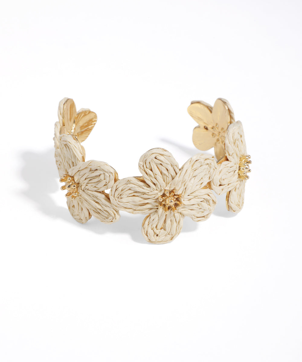 Gold floral bracelet on a white background