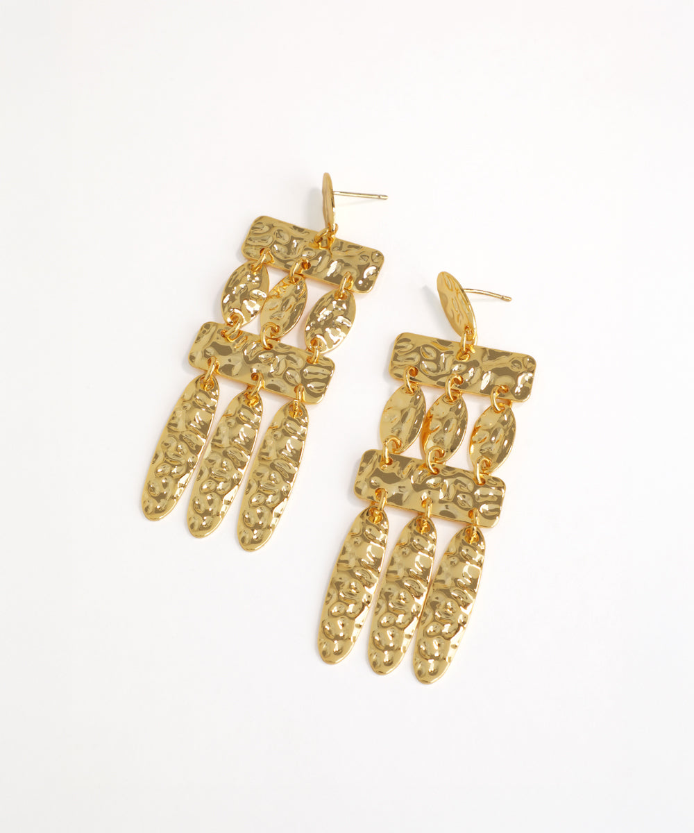 Gold chandelier earrings on a white background