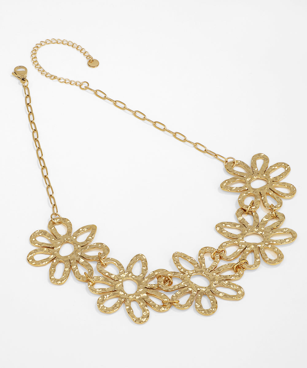 Gold floral necklace on a white background