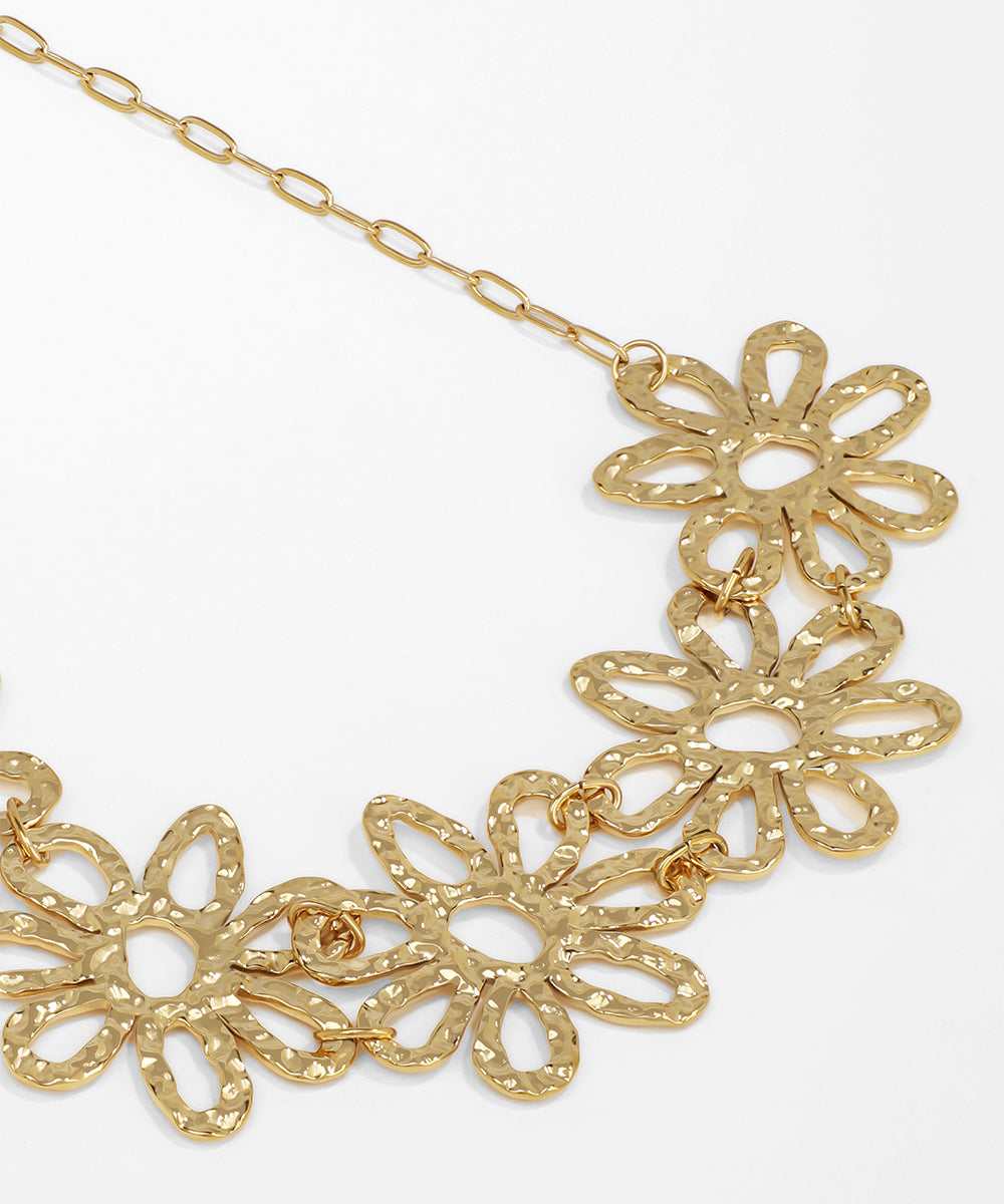 Gold floral necklace on a white background